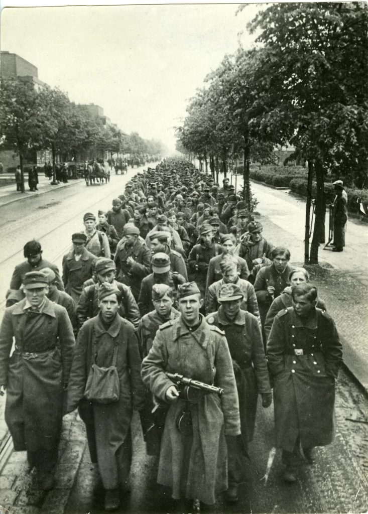 Soldier of the Red Army leads captured Wehrmacht child soldiers through Berlin-Reinickendorf in May 1945 to be transported to a camp as prisoners of war © DHM