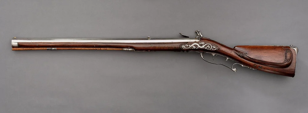 The picture shows a flintlock rifle, a historical European muzzle-loading firearm.